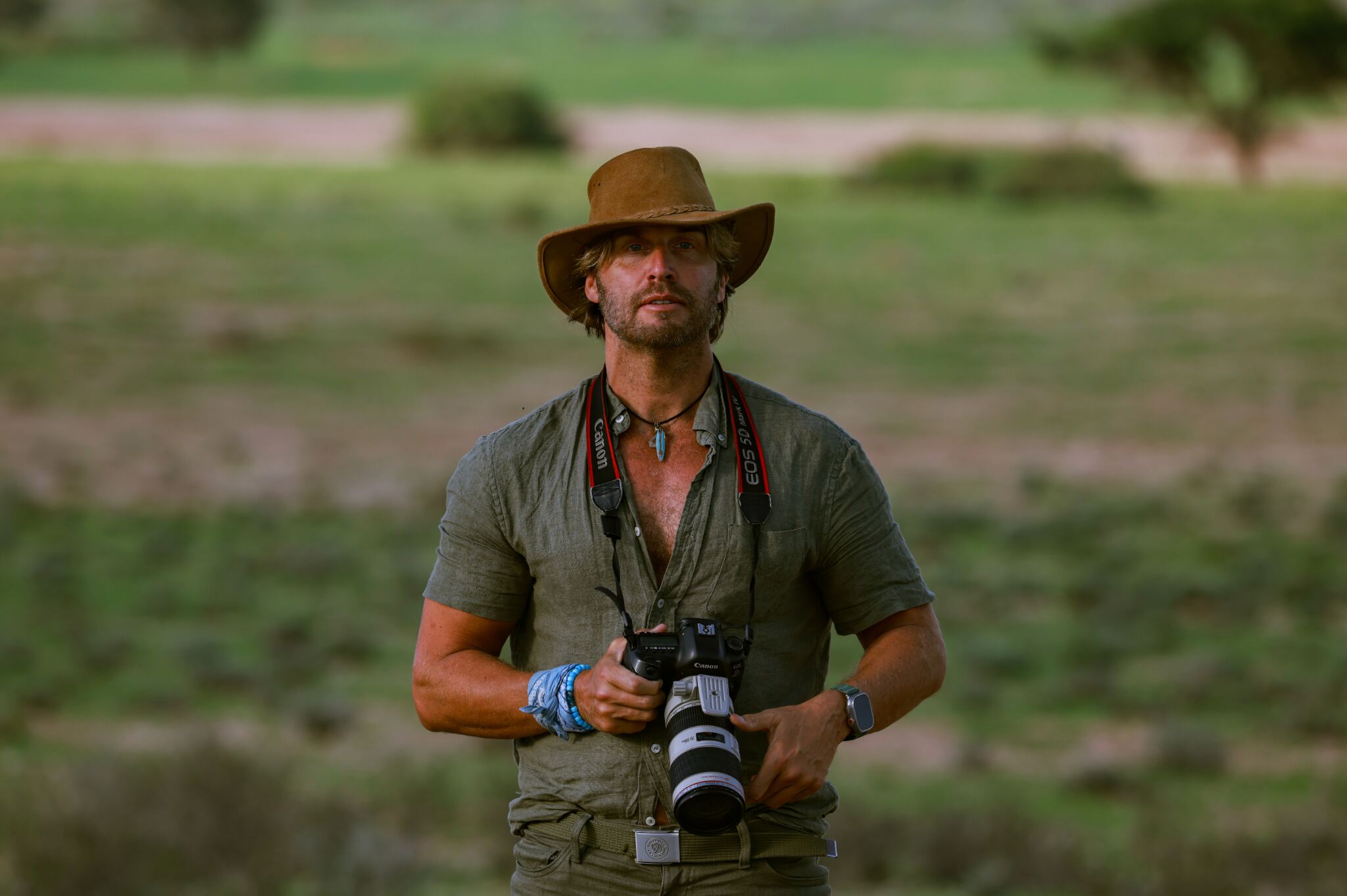 Sky B holding a professional Canon camera in the field